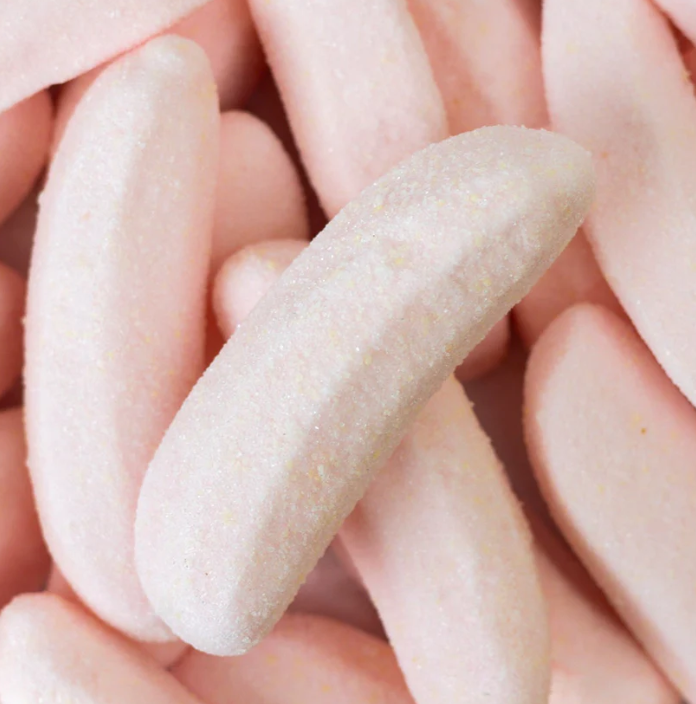 Close-up of pink, banana-shaped candies with a sour coating